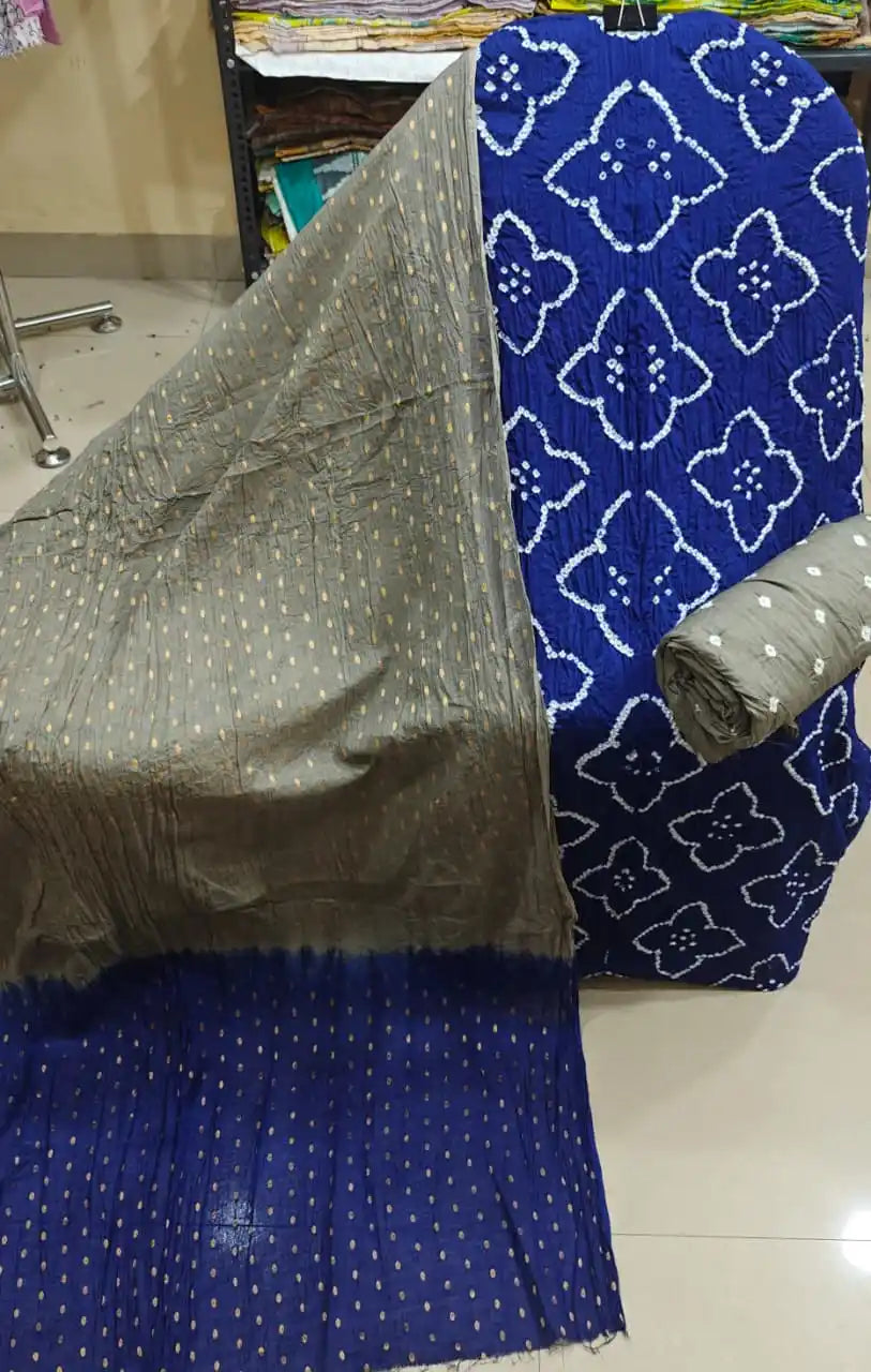 Vibrant blue cotton bandhani unstitched suit material with clean white tie-dye prints, displayed with a sober grey contrast dupatta.