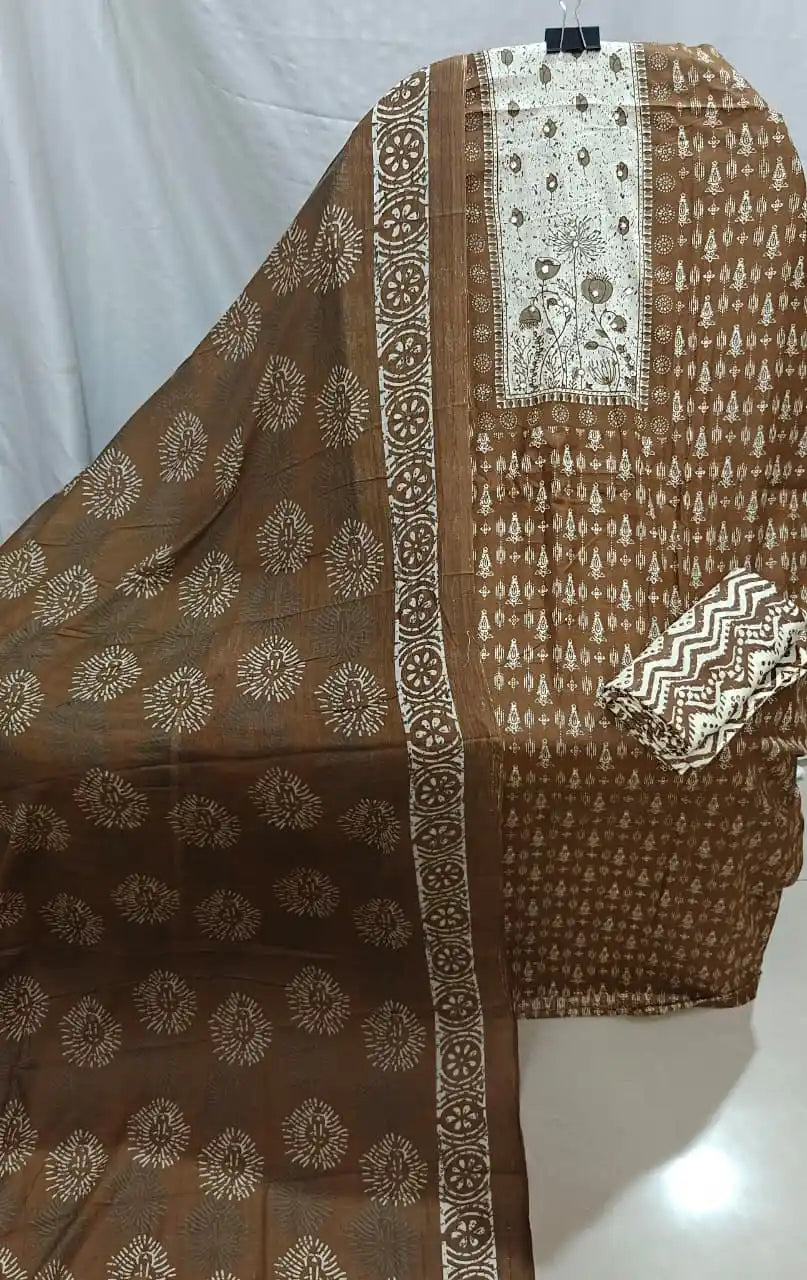 A beautiful display of a coffee brown cotton unstitched dress material by ASC, with a cream floral panel on the chest, small geometric prints, and a matching soft cotton dupatta.