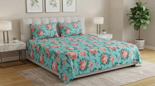 Cotton floral print queen size bedsheet set on a bed with decorative pillows in a stylish bedroom setting.