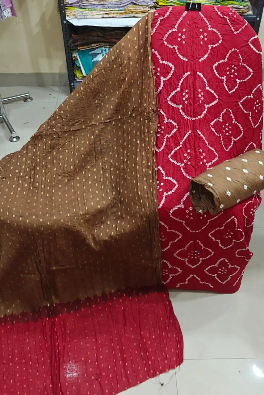 Deep crimson red bandhani unstitched dress material with square tie-dye motifs, complemented by a soft choco-brown contrast dupatta.