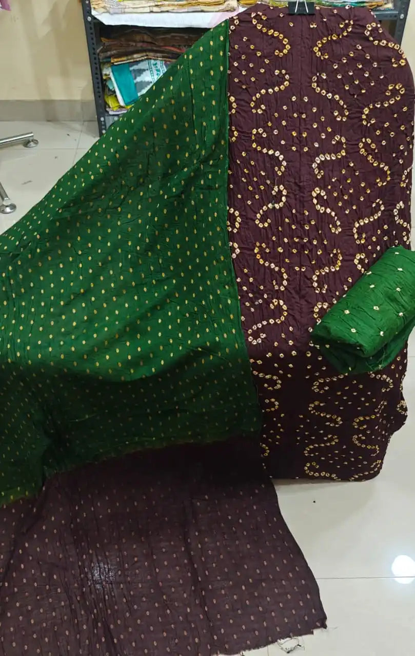 Sober dark plum or wine-toned bandhani dress material with yellow-white tie-dye highlights, accompanied by a contrast olive green dupatta.