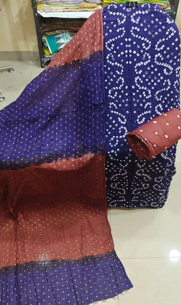 Rich navy blue cotton bandhani suit material showcasing white tie-dye designs, styled with a contrast rust maroon and blue dual-tone dupatta.