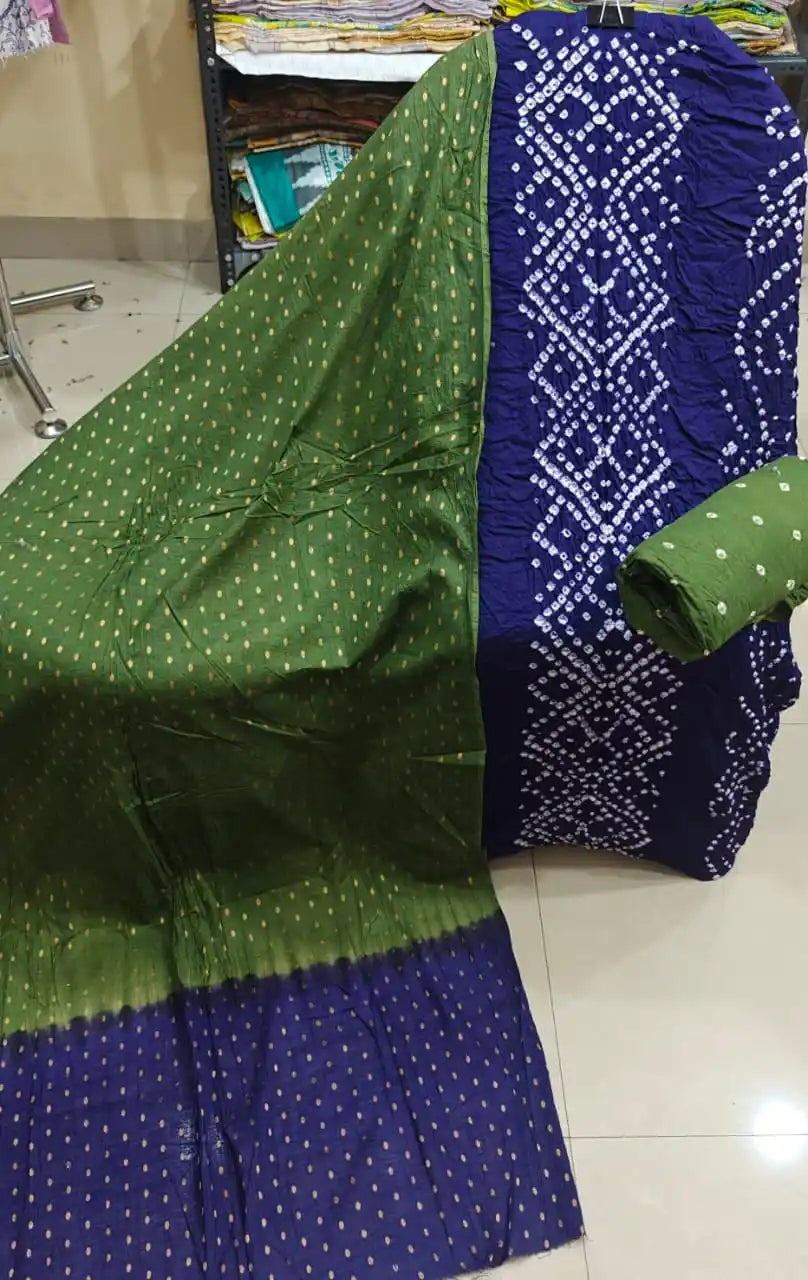 Deep royal blue cotton bandhani dress material with white traditional rings, paired beautifully with a dual-tone olive green and blue dupatta.