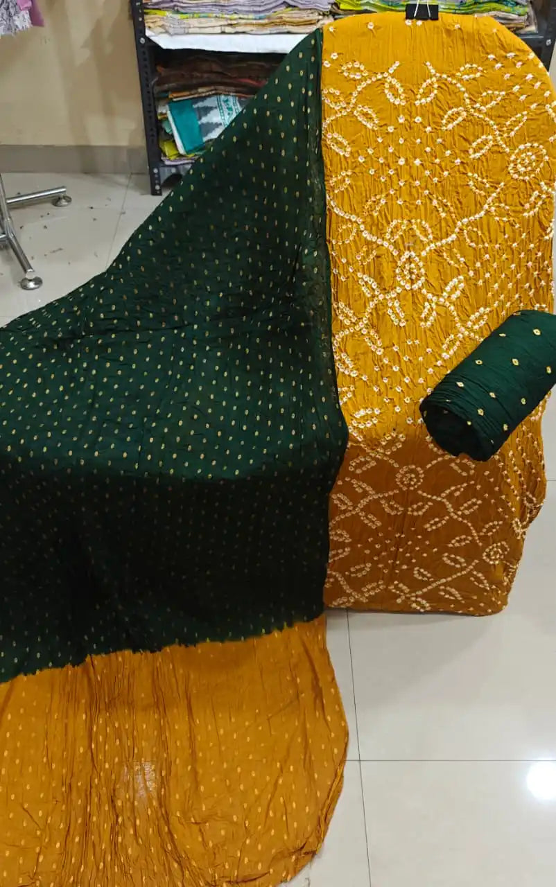 Mustard yellow cotton bandhani dress material showcasing heavy tie-dye work, paired with a classic dark green contrast dupatta.