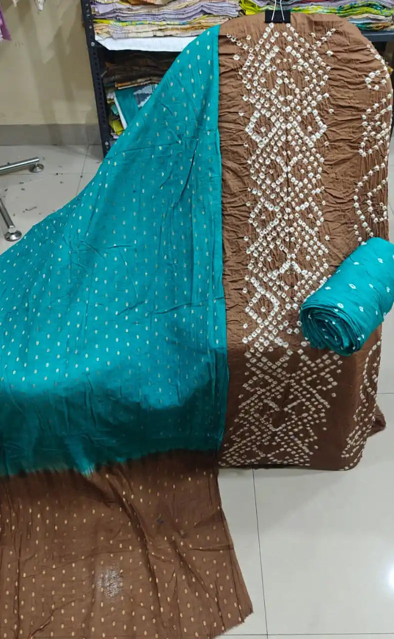 Earthy brown cotton bandhani suit material showcasing a detailed vertical tie-dye panel, styled with a striking turquoise blue contrast dupatta.
