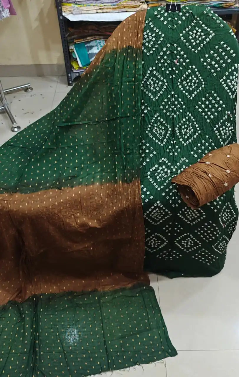 Dark forest green cotton bandhani dress material featuring traditional square tie-dye blocks, accompanied by a rich mud-brown contrast dupatta.