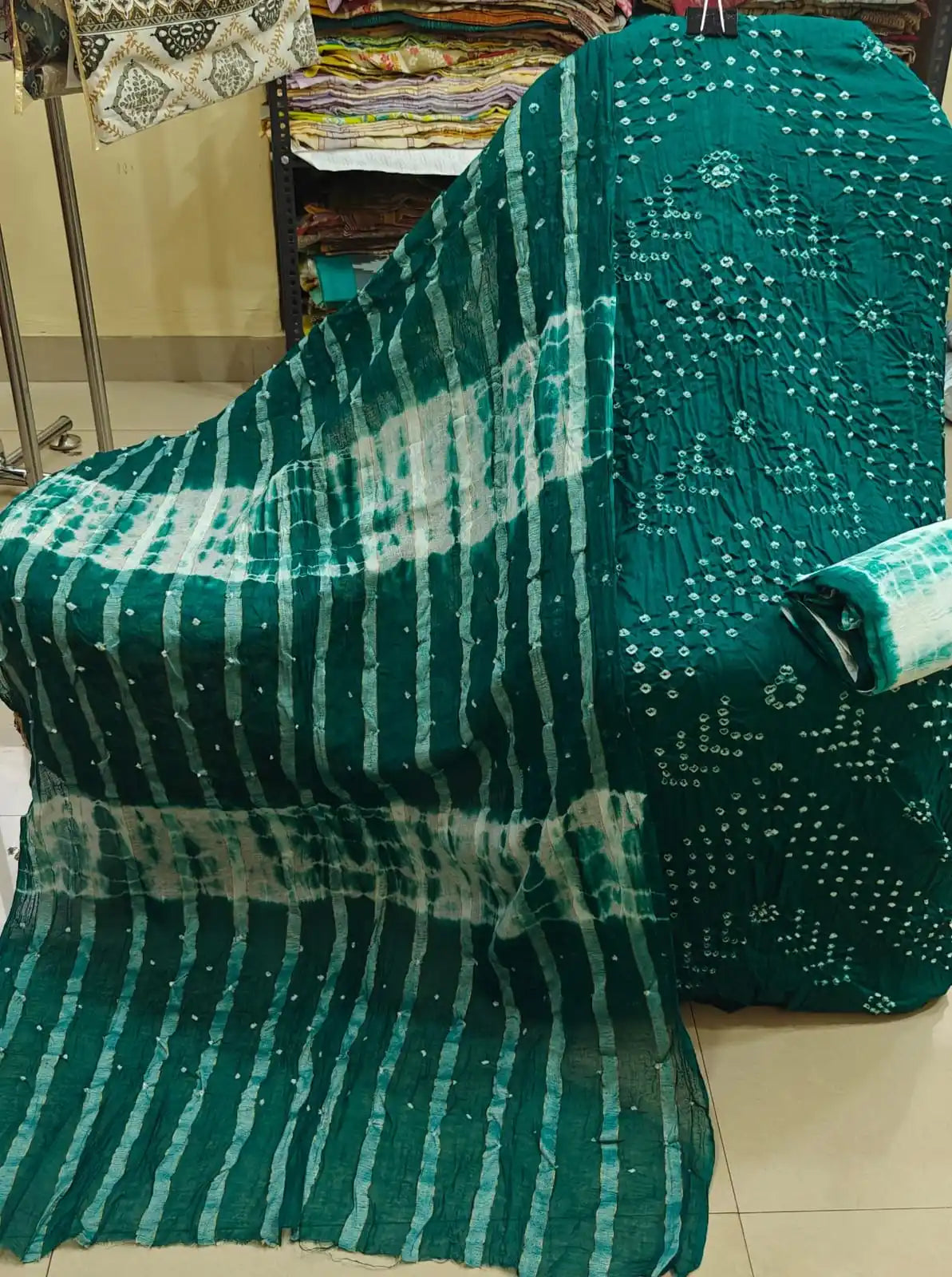Earthy brown cotton bandhani suit material showcasing a detailed vertical tie-dye panel, styled with a striking turquoise blue contrast dupatta.