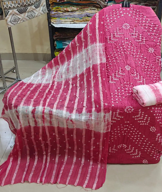 Soft peach-pink cotton bandhani suit fabric featuring intricate white tie-dye leaf patterns, accompanied by a dark olive green contrast dupatta.
