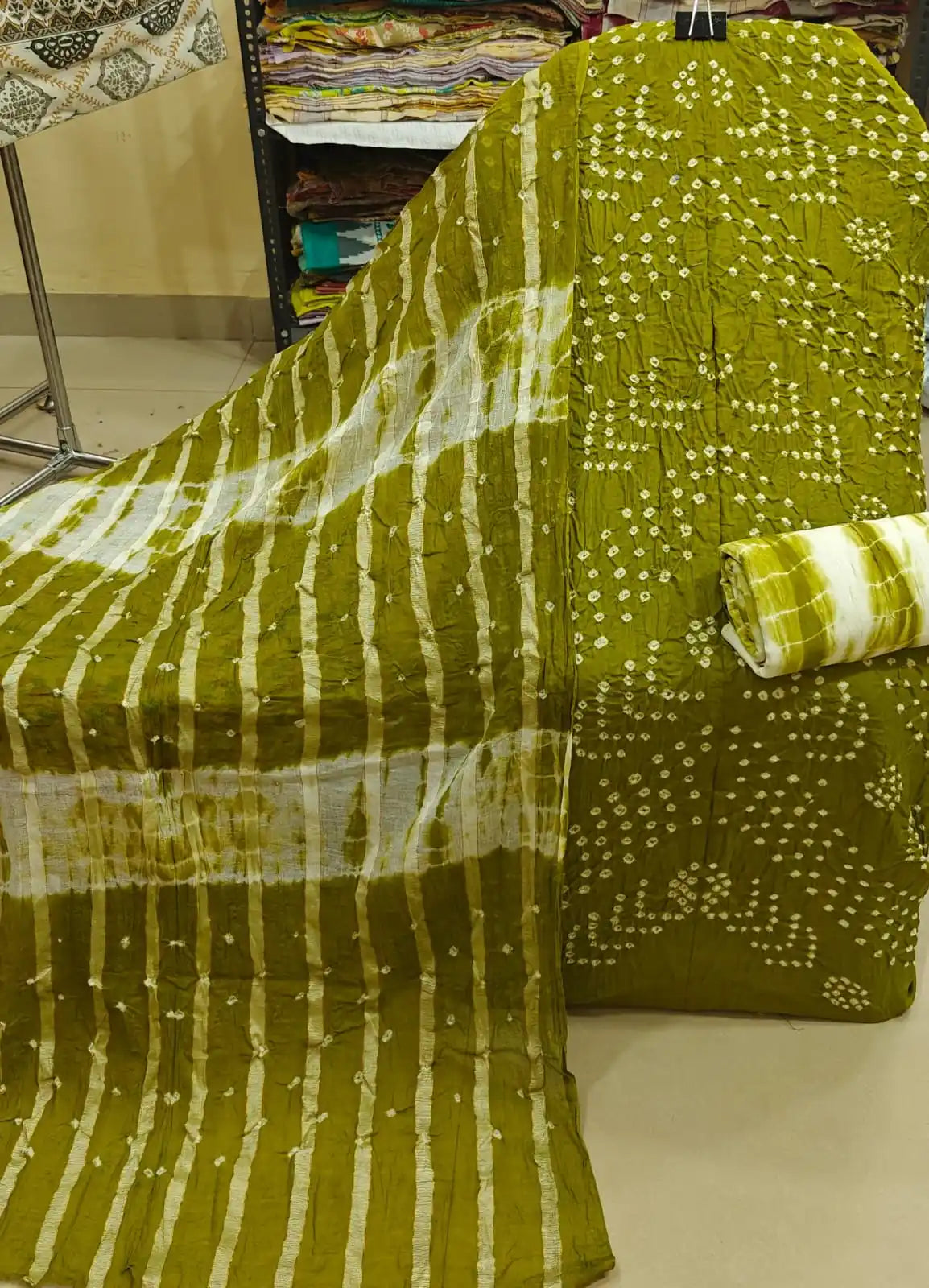 Deep wine-colored cotton bandhani dress material showcasing bold oval tie-dye rings, paired beautifully with an olive green contrast dupatta.
