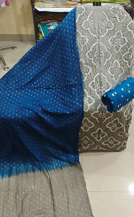 Charcoal grey cotton bandhani unstitched fabric with intricate white geometric designs, displayed with a beautiful contrast dark blue dupatta.