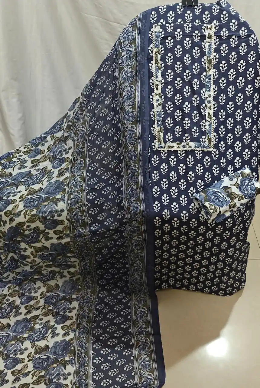 A neat flat lay presentation of a navy blue cotton unstitched suit fabric by ASC, decorated with white mini booti prints, a matching rectangular border neck panel, and a coordinated white and blue floral print dupatta.