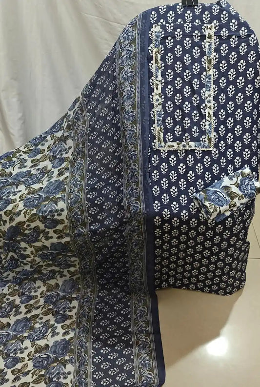 A neat flat lay presentation of a navy blue cotton unstitched suit fabric by ASC, decorated with white mini booti prints, a matching rectangular border neck panel, and a coordinated white and blue floral print dupatta.