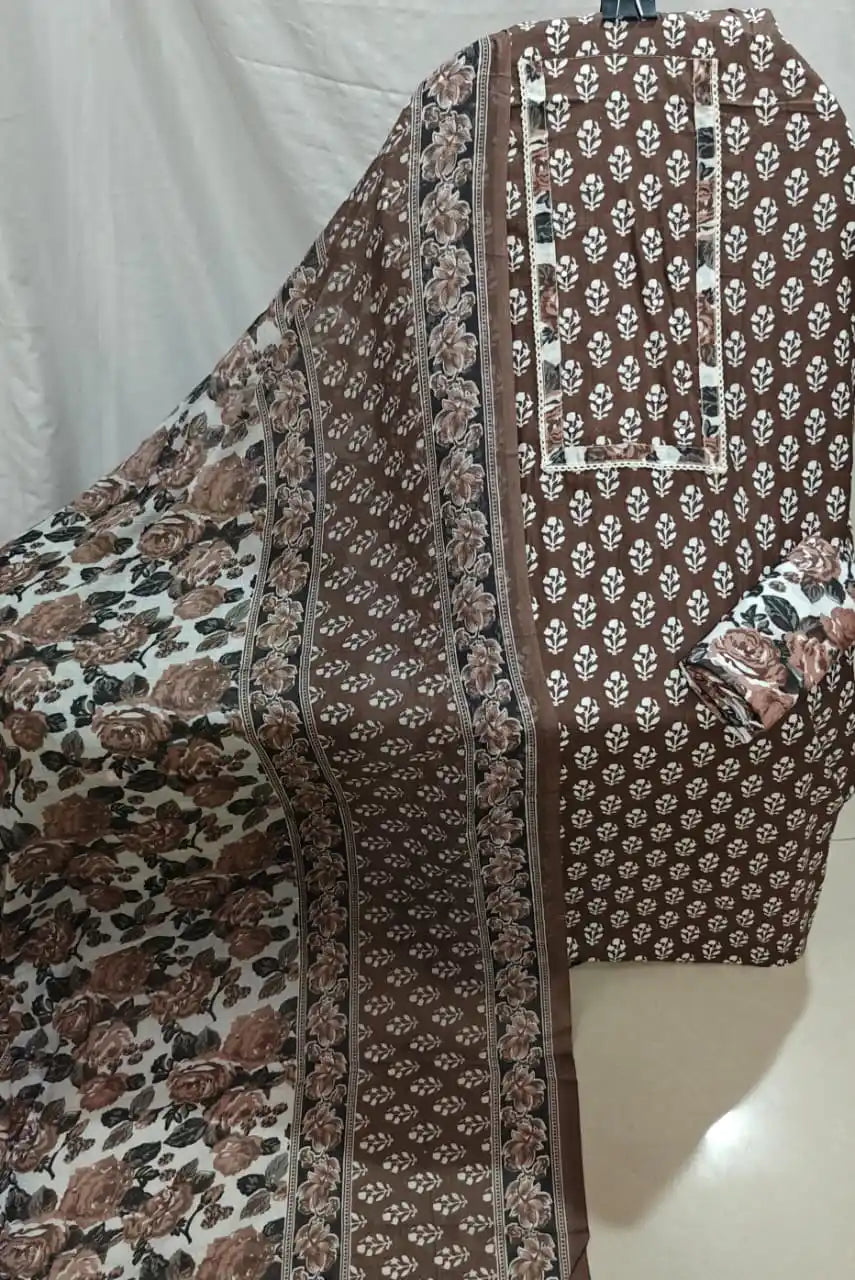 A detailed view of a chocolate brown cotton unstitched dress material by ASC, highlighting white ethnic booti prints across the fabric, a matching border neck design, and an elegant brown and white rose-patterned dupatta.