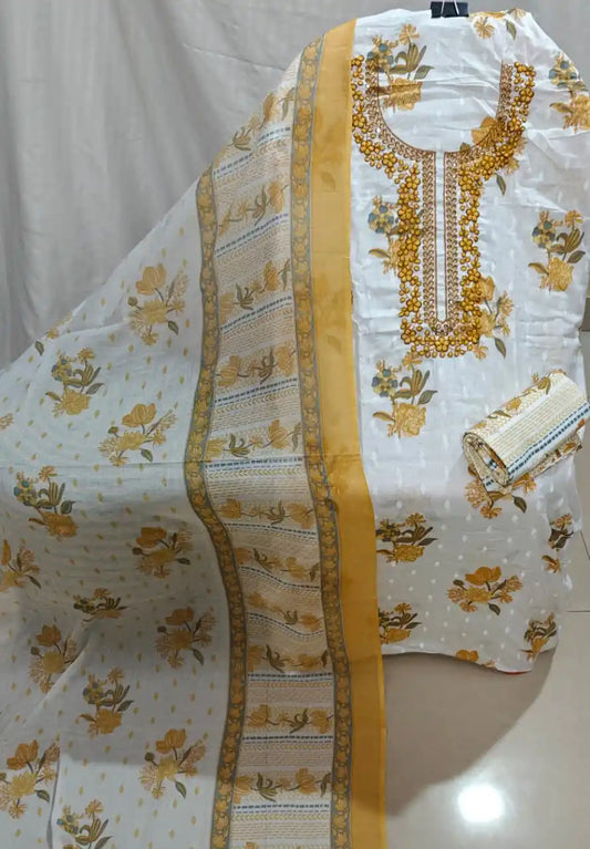 A beautiful white cotton unstitched suit material by ASC, decorated with yellow floral booti prints, a heavily embroidered yellow-toned round neck patch design, and a matching patterned border dupatta.