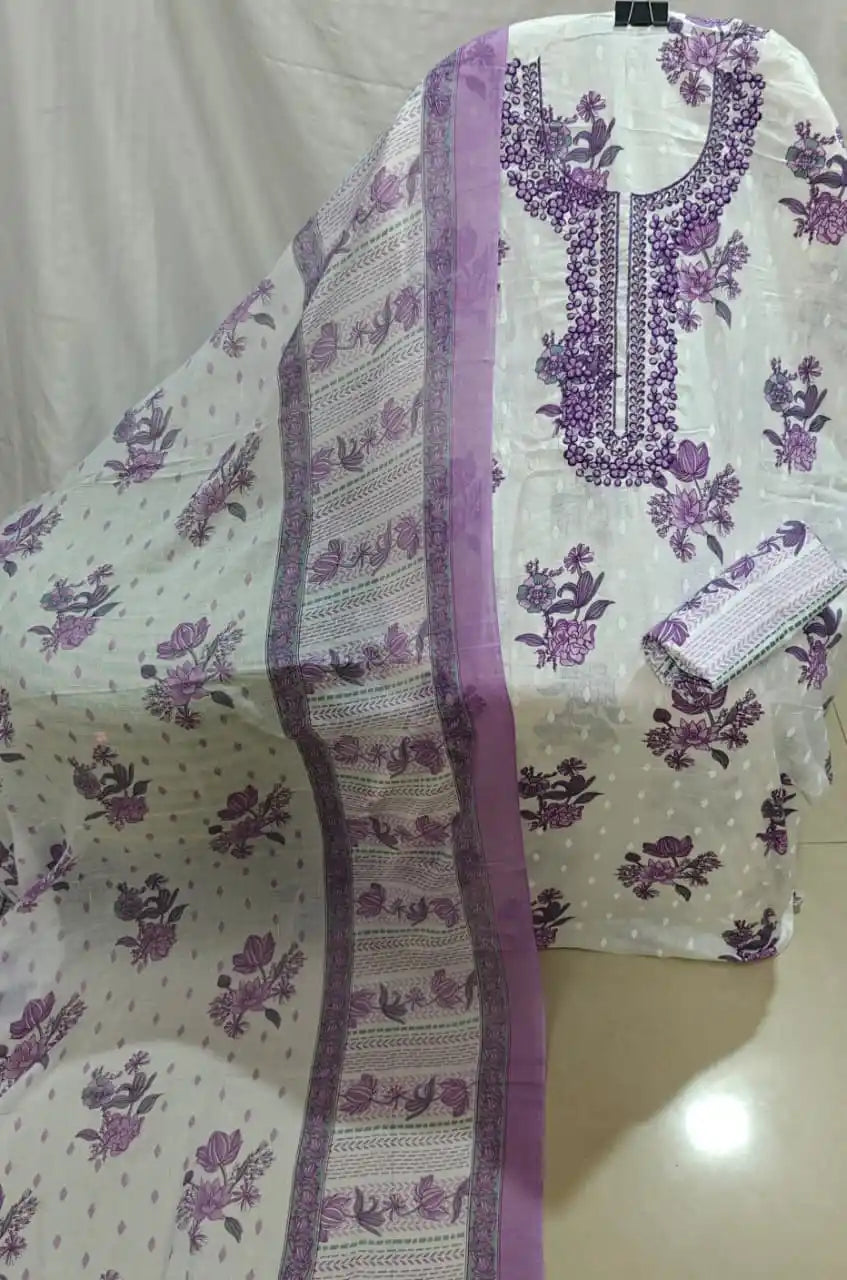 A presentation of a white cotton unstitched suit fabric by ASC, adorned with purple flower motifs, an elegant purple embroidered neck design, paired with a matching printed border dupatta.