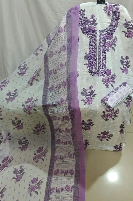 A presentation of a white cotton unstitched suit fabric by ASC, adorned with purple flower motifs, an elegant purple embroidered neck design, paired with a matching printed border dupatta.