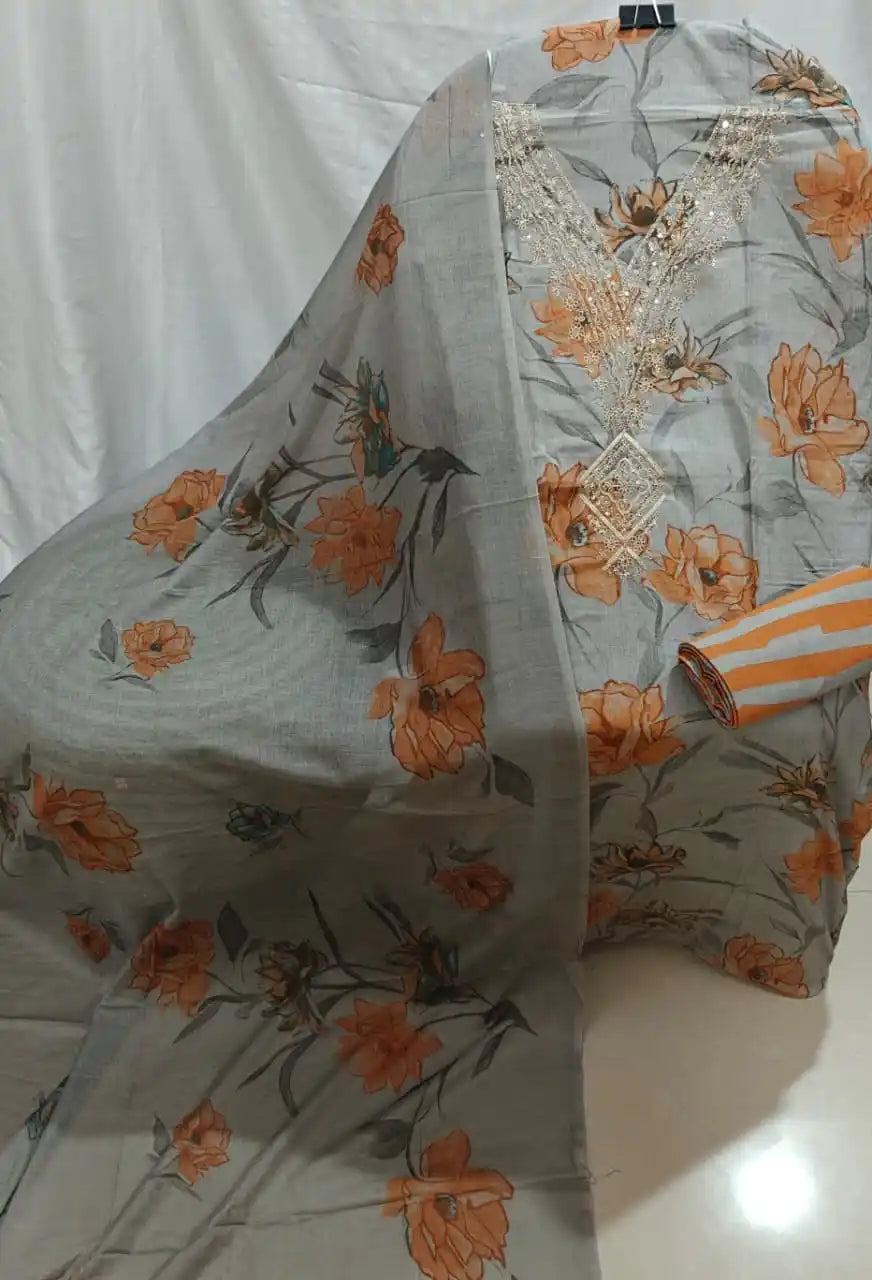 A presentation of a grey cotton unstitched suit material by ASC, highlighting large orange floral clusters, a detailed light beige embroidered V-neck accent, and a matching printed dupatta.