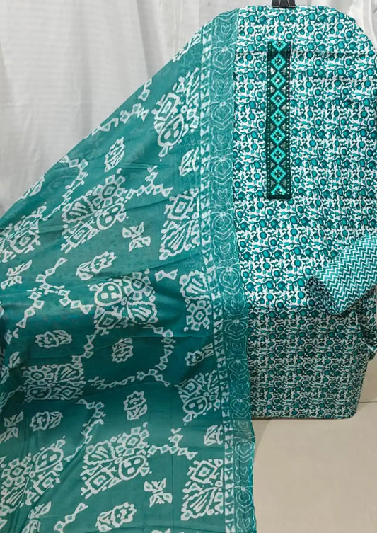 A striking teal blue cotton unstitched dress material by ASC, featuring a dense micro floral pattern on the shirt, a matching embroidered neck panel, and a beautiful teal dupatta with crisp white geometric batik prints.