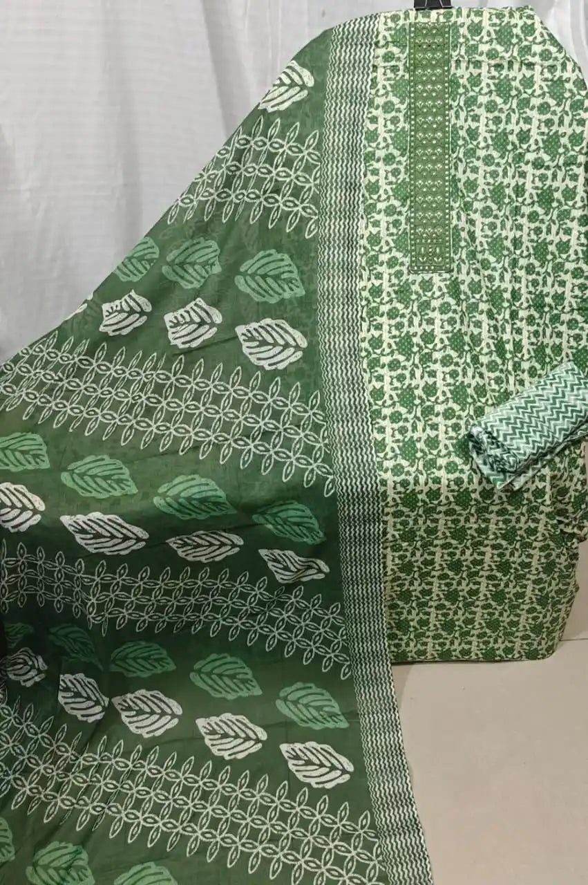 A fresh fern green cotton unstitched suit fabric by ASC, featuring a dense micro floral vine print on the shirt, a matching embroidered vertical neck panel, and a coordinated green dupatta adorned with distinct white leaf shapes and geometric borders.