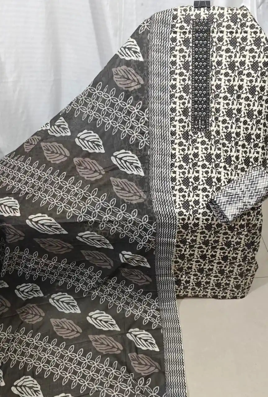 A premium charcoal black cotton unstitched dress material by ASC, showcasing an all-over micro block print design, a detailed black embroidered rectangular neck strip, and a matching black dupatta displaying white organic leaf motifs and wavy borders.