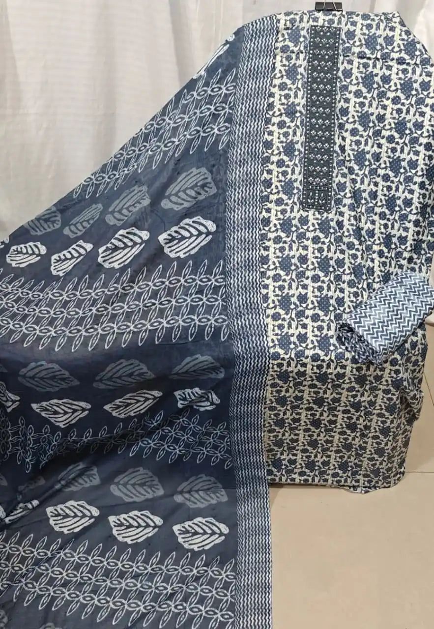 A striking indigo blue cotton unstitched dress material by ASC, featuring a micro floral texture print on the shirt fabric, a dark blue embroidered neck panel, and a coordinated indigo dupatta showcasing bold white leaf block prints and zig-zag borders.