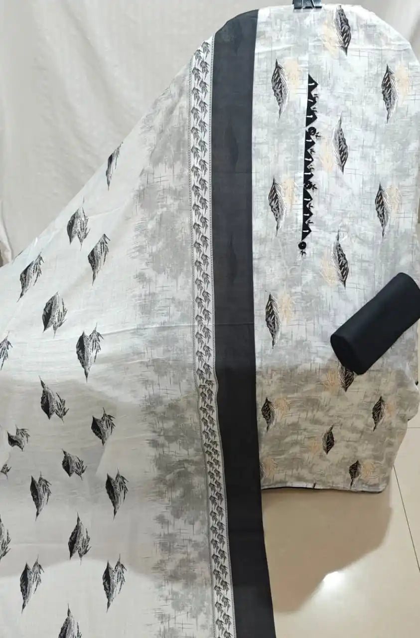 A classy light grey and black cotton unstitched dress material by ASC, featuring a textured brush-stroke background with floating black leaf-feather motifs, a dark embroidered neck patch with sharp triangle lace edging, a solid black bottom fabric, and a matching light grey dupatta with leaf graphics and dark border bands.