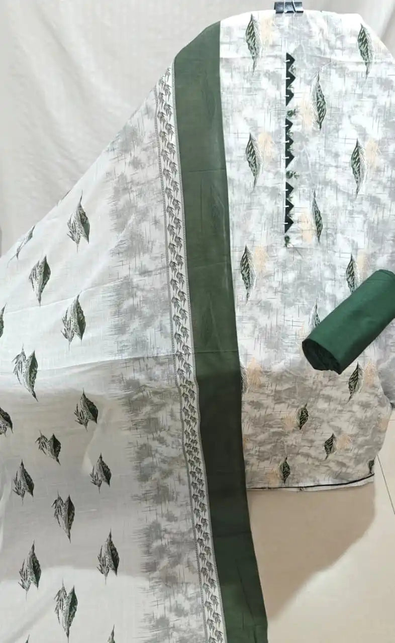 A neat presentation of a light grey and olive green cotton unstitched suit material by ASC, featuring textured print with green leaf patterns on the shirt, a dark green embroidered neck patch with triangle lace, a solid green bottom fabric, and a light grey dupatta with broad green borders.