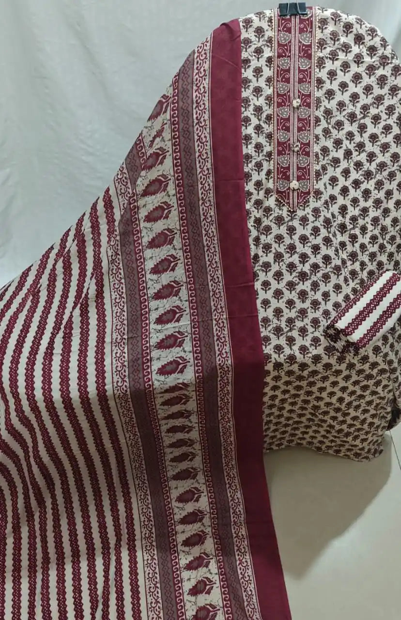 A rich burgundy maroon and off-white cotton unstitched suit fabric by ASC, featuring traditional floral bootis printed all over the light shirt, an intricate embroidered neck panel with fabric buttons, a striped bottom fold, and a matching dupatta detailed with vertical maroon scalloped stripes and decorative leafy end-borders.