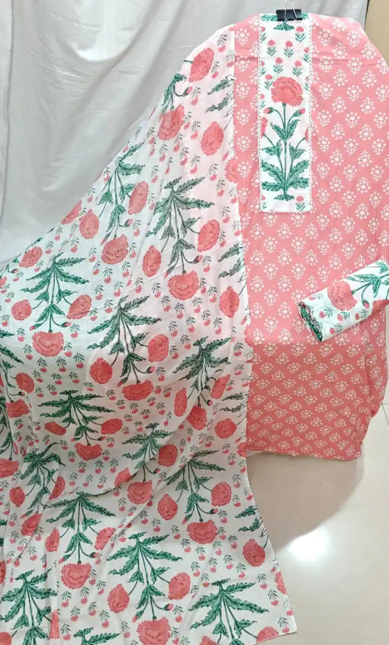 A delicate coral peach cotton unstitched suit material by ASC, featuring a tiny white floral print on the shirt, a contrasting white neck panel with a prominent pink flower motif and lace trim, a printed bottom piece, and a matching white dupatta adorned with vibrant pink floral stems.