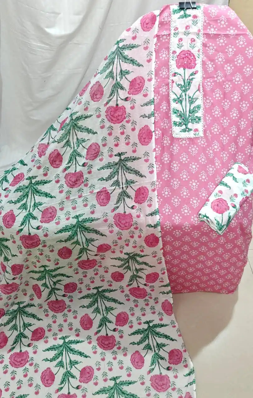 A charming baby pink cotton unstitched suit fabric by ASC, showcasing a white bootie print across the shirt, an elegant white embroidered neck panel, a matching bottom fold, and a draped light-colored dupatta with large pink flower prints.