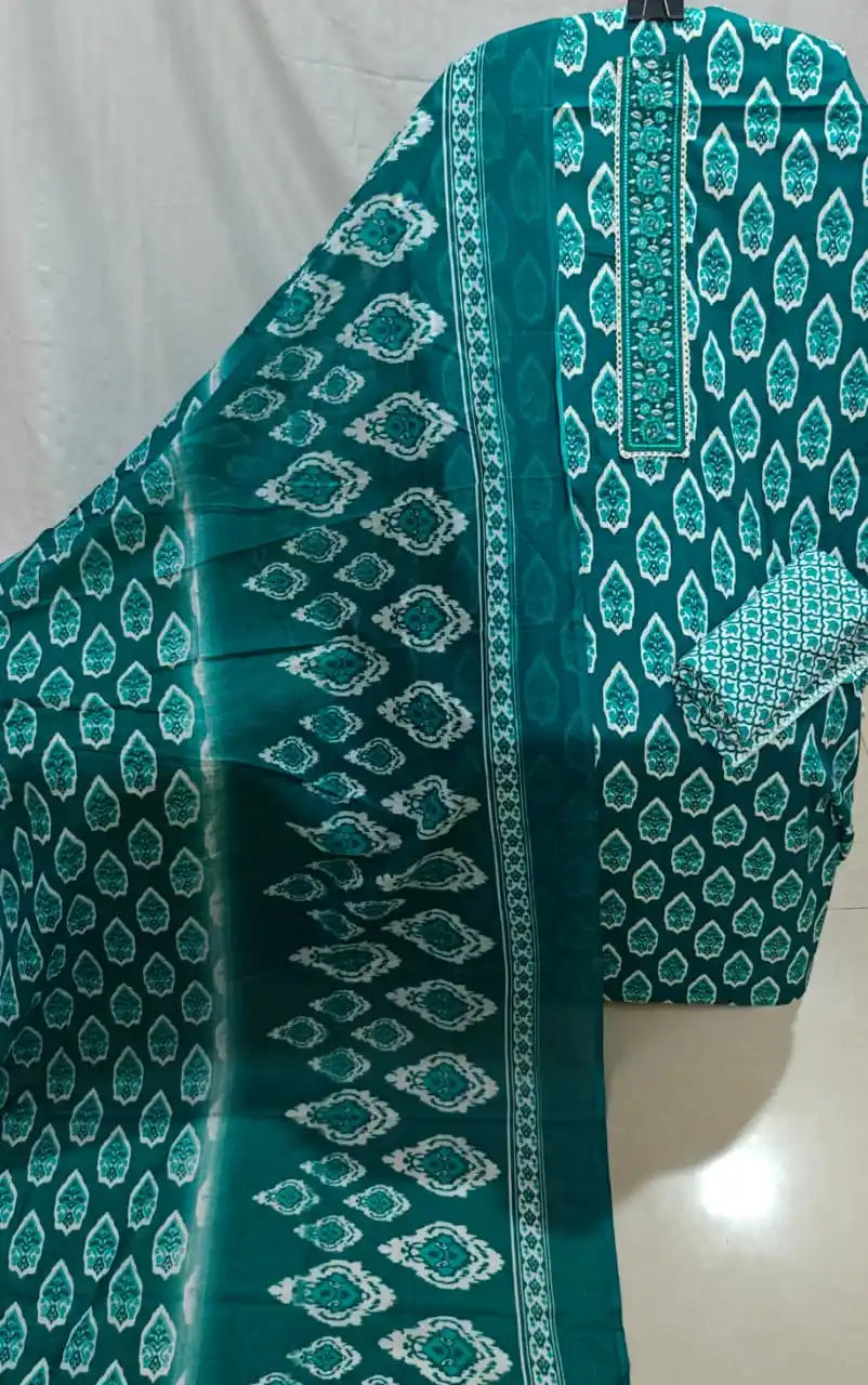 A neat display of a rama green cotton unstitched dress material by ASC, with white ethnic leaf prints, a detailed embroidered neck border, and a matching printed dupatta.