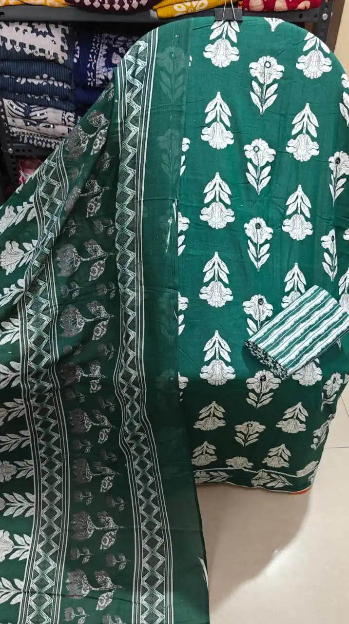 Dark green botanical print cotton suit with white botanical tree designs and a matching dupatta.