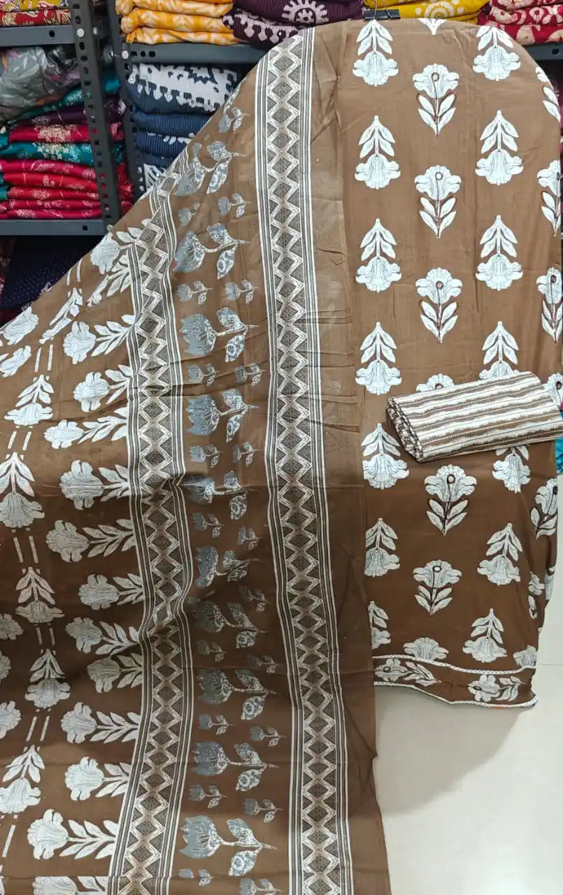 Brown floral cotton dress material featuring white flower patterns, perfect for office wear and casual outings.