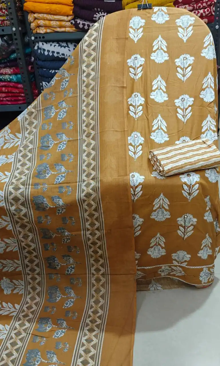 Mustard yellow summer suit featuring botanical prints on fine cotton fabric and coordinated dupatta.