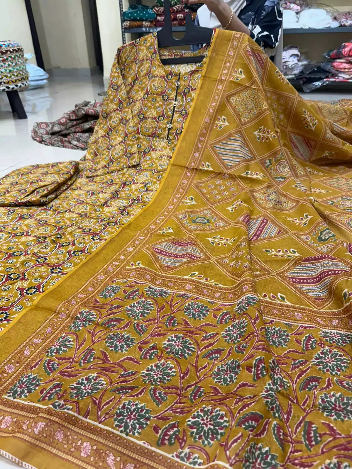 Mustard yellow readymade cotton Anarkali kurta featuring a detailed diamond grid pattern and a matching floral printed dupatta.