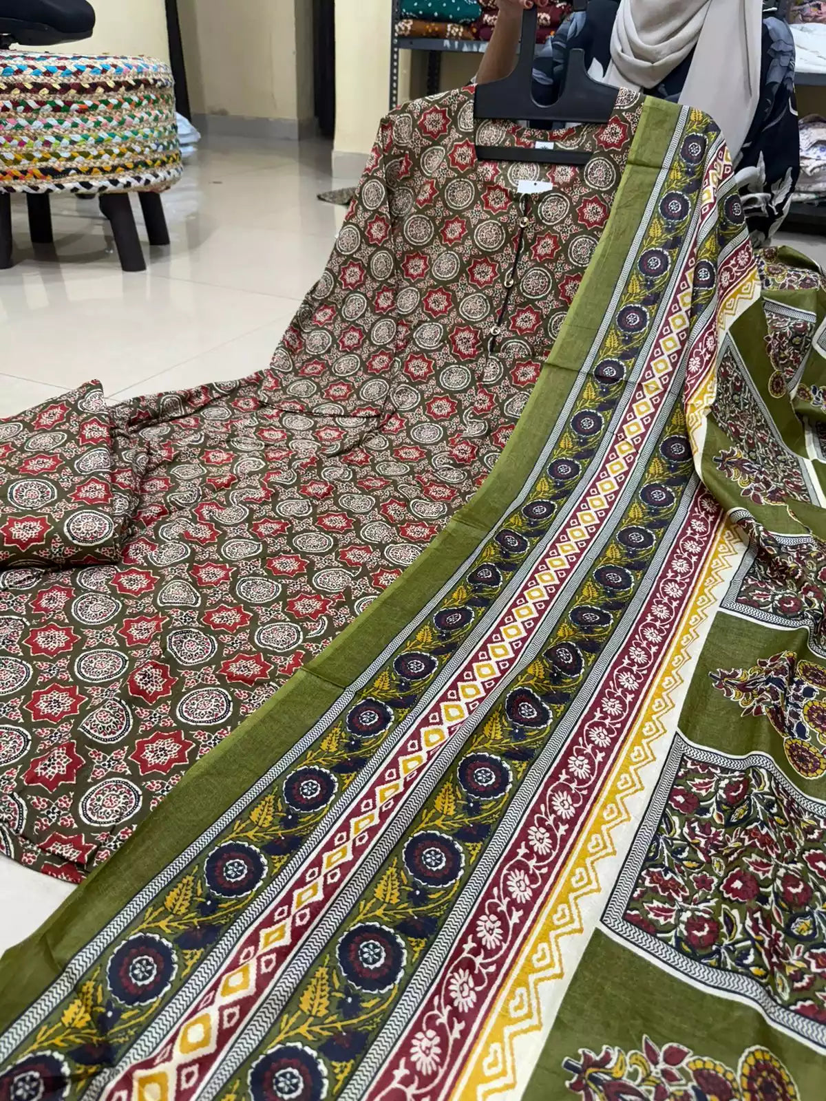Olive green and red ethnic motif printed cotton Anarkali suit set with a coordinating multi-border printed dupatta.
