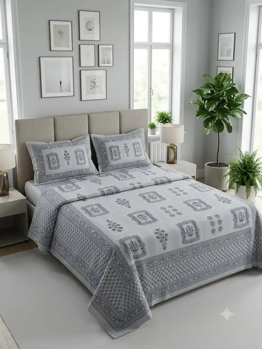 Jaipuri cotton super king bedsheet displayed on a modern bed with decorative pillows and plants in a stylish bedroom.