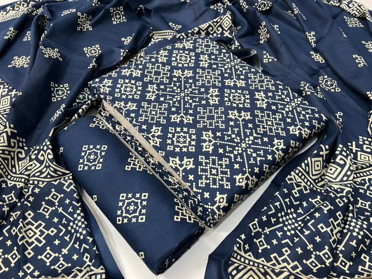 A sophisticated navy blue rayon unstitched dress material by ASC, featuring an all-over beige Kutchi cross-stitch inspired geometric lattice print on the shirt, a matching geometric bottom fabric, and a draped dupatta with rich traditional Kutchi border motifs.