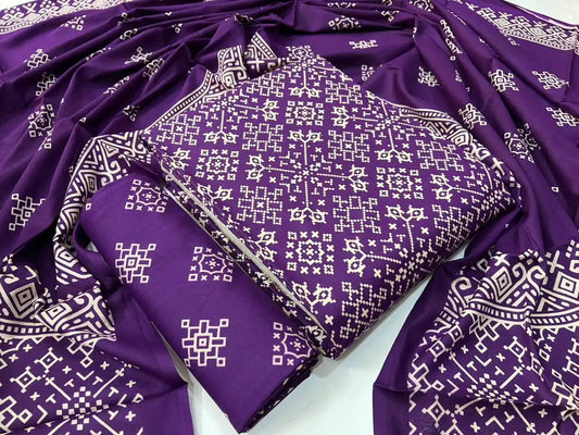 A royal deep purple rayon unstitched suit material by ASC, detailed with a cream Kutchi geometric grid print, a matching printed bottom fold, and an elegant draped dupatta with intricate tribal geometric patterns.