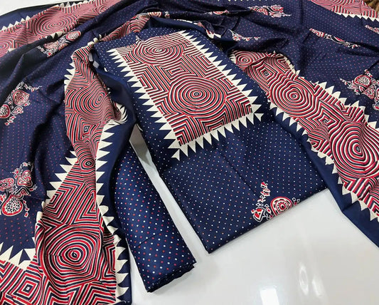 A stylish navy blue rayon unstitched dress material by ASC, featuring a micro dot base on the shirt and bottom, an eye-catching rectangular neck panel with red and off-white concentric circle prints and saw-tooth edging, paired with a matching graphic dupatta.