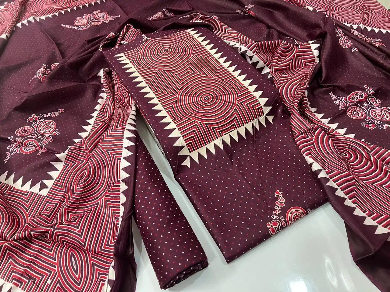 A rich plum wine rayon unstitched suit material by ASC, featuring a micro dot base, a bold rectangular neck patch printed with concentric circles and saw-tooth borders, paired with a matching graphic printed dupatta.