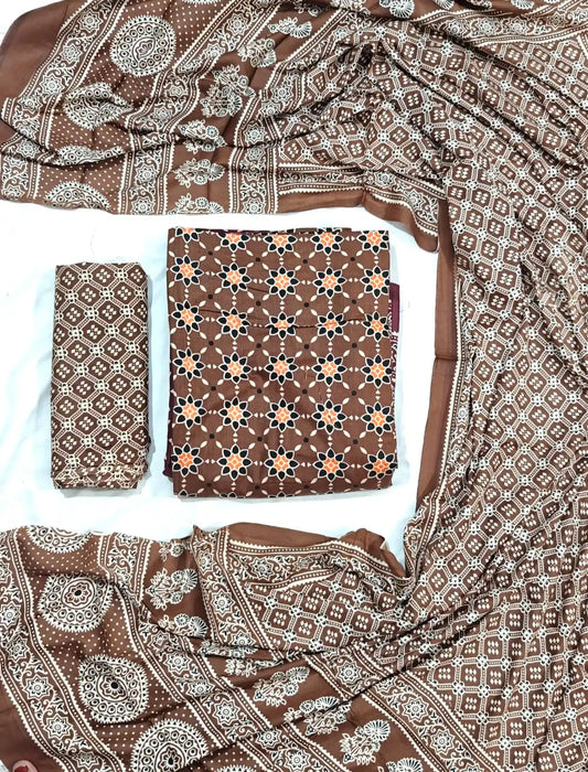 An elegant coffee brown rayon unstitched suit fabric by ASC, detailed with an orange and black star lattice design on the kurta, a Kutchi patterned bottom cloth, and an elaborate printed dupatta with traditional ethnic borders.