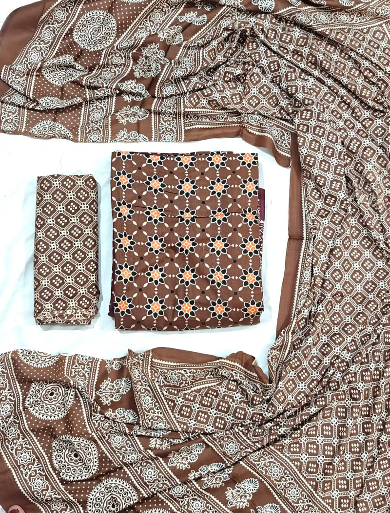 An elegant coffee brown rayon unstitched suit fabric by ASC, detailed with an orange and black star lattice design on the kurta, a Kutchi patterned bottom cloth, and an elaborate printed dupatta with traditional ethnic borders.
