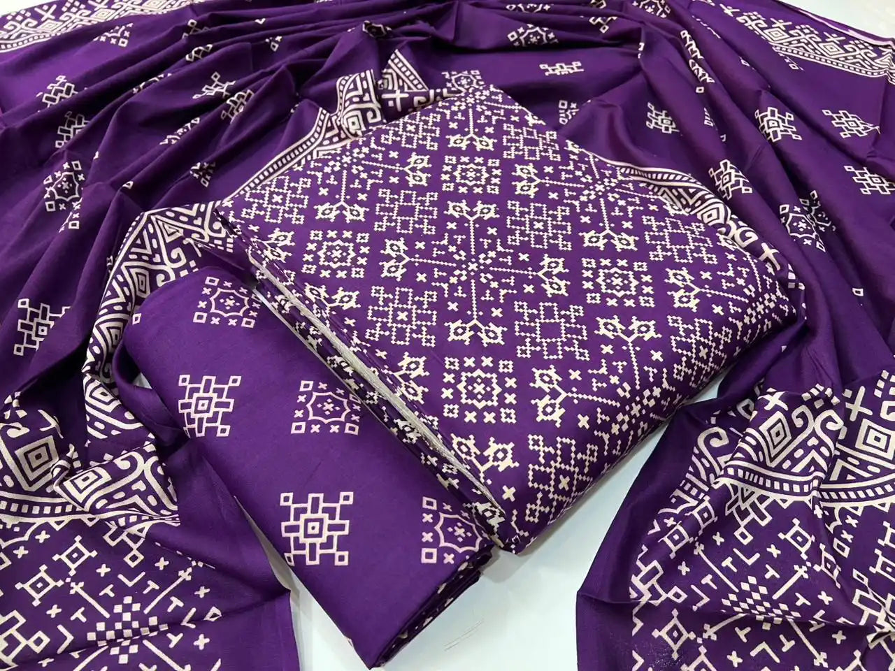 Deep purple unstitched rayon salwar kameez material with traditional all-over geometric block print and matching dupatta.
