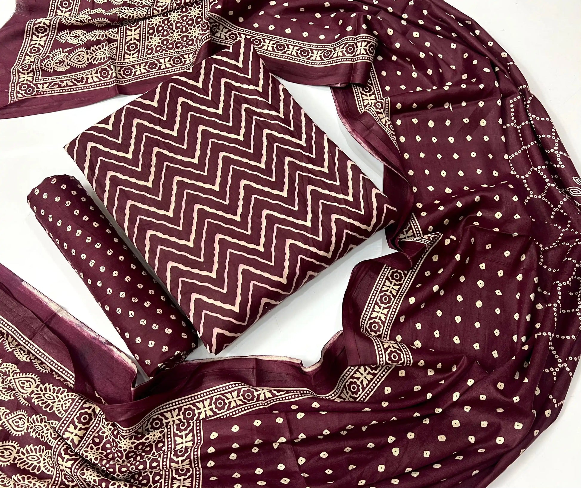Deep wine maroon unstitched rayon suit set with cream traditional handblock ajrakh print, matching printed bottom, and dupatta.