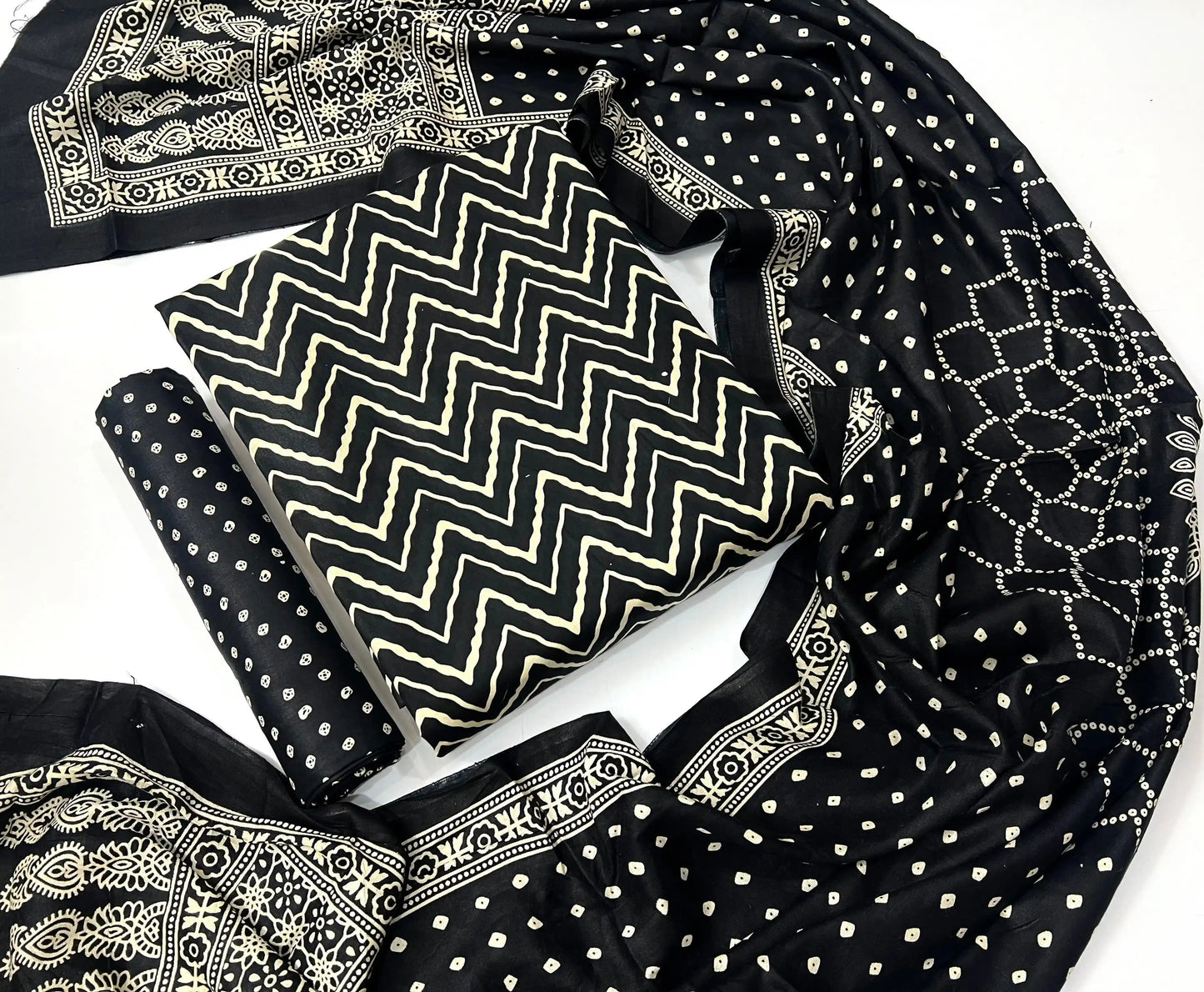 Classic jet black unstitched rayon suit material featuring contrast cream handblock ajrakh print and matching bordered dupatta.