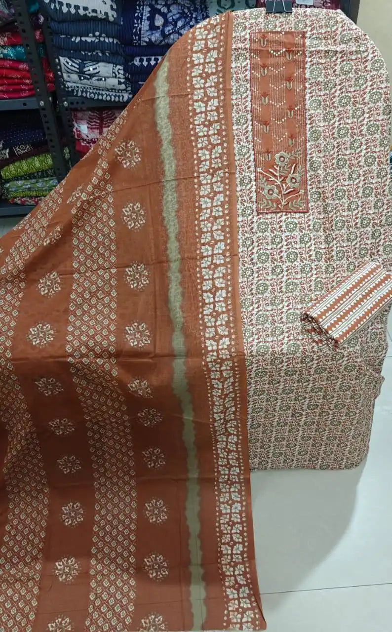 rust orange unstitched ethnic suit featuring intricate off-white block prints and vertical neck embroidery.