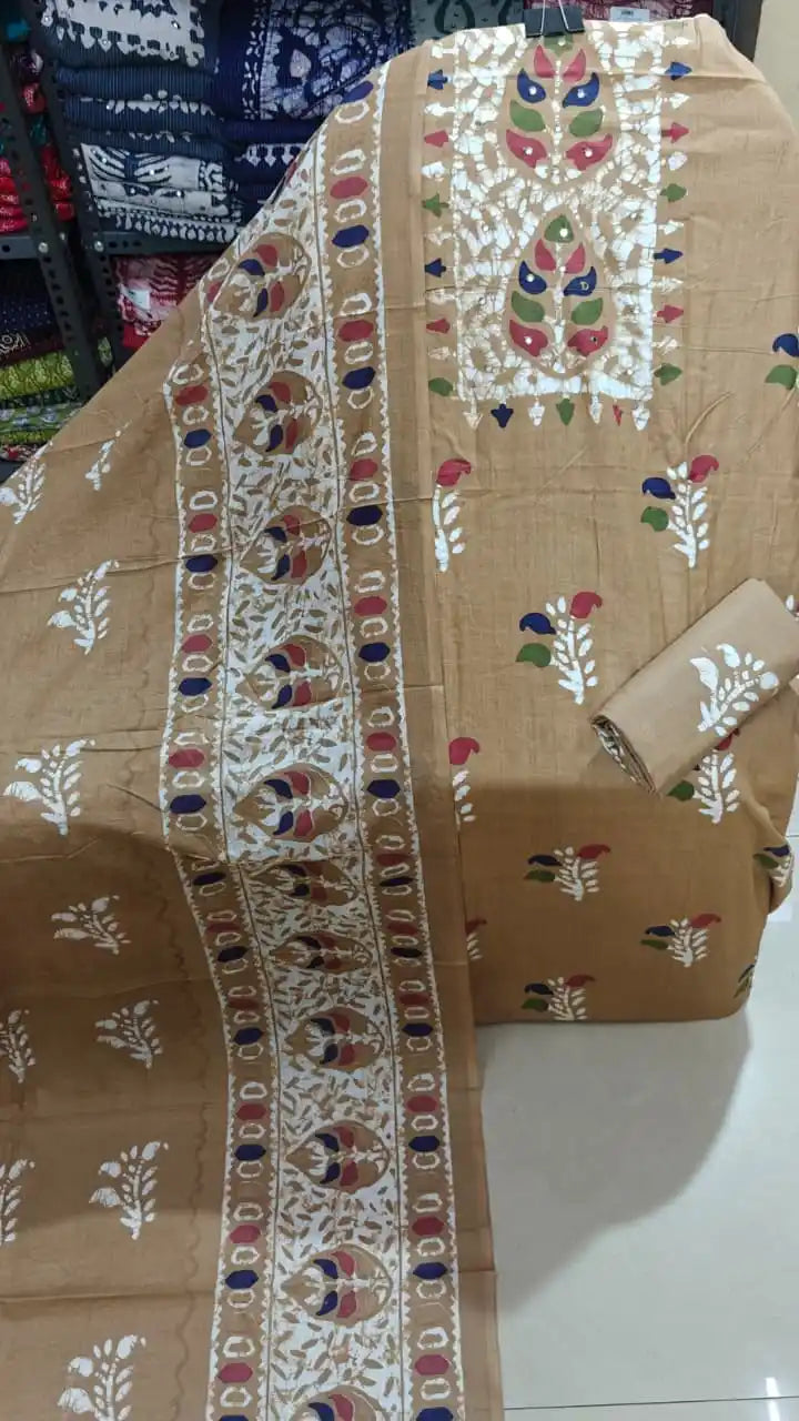 Elegant chiku gold cotton unstitched suit set with white batik border dupatta.