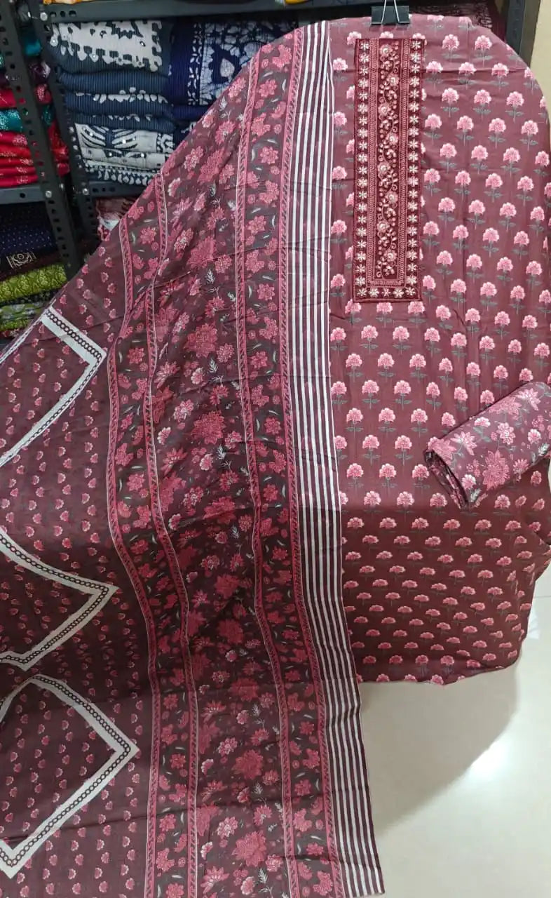 Wine burgundy floral unstitched suit featuring dense pink floral block prints and zari-embroidered border.