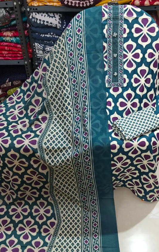 Teal blue unstitched suit fabric featuring large floral motifs and detailed neck design, ideal for summer wear. By ASC